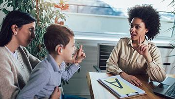 Person Testing a child for hearing issues.